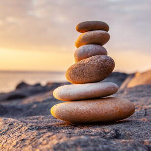 Stones pyramid on the seashore at sunset